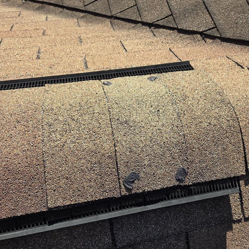 Roof shingles around vent pipe with sealant and nails