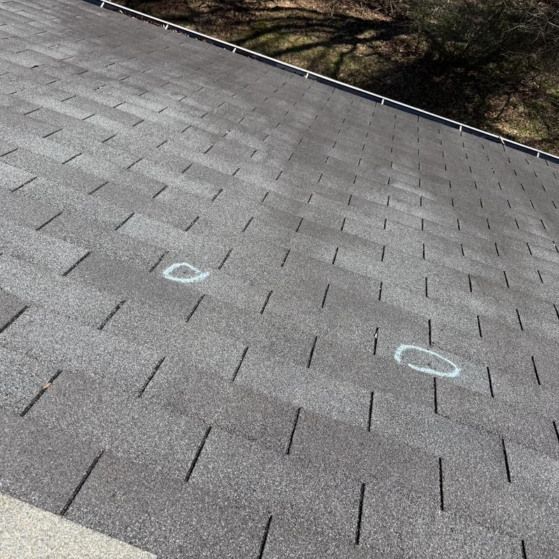 Asphalt shingles with chalk markings on roof surface