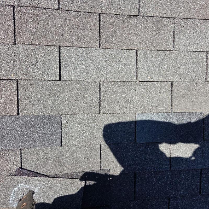 Box vent on shingle roof with shadow and caulking