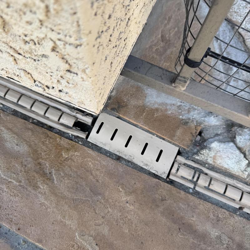 Drainage channel cover and patio slab edge in backyard