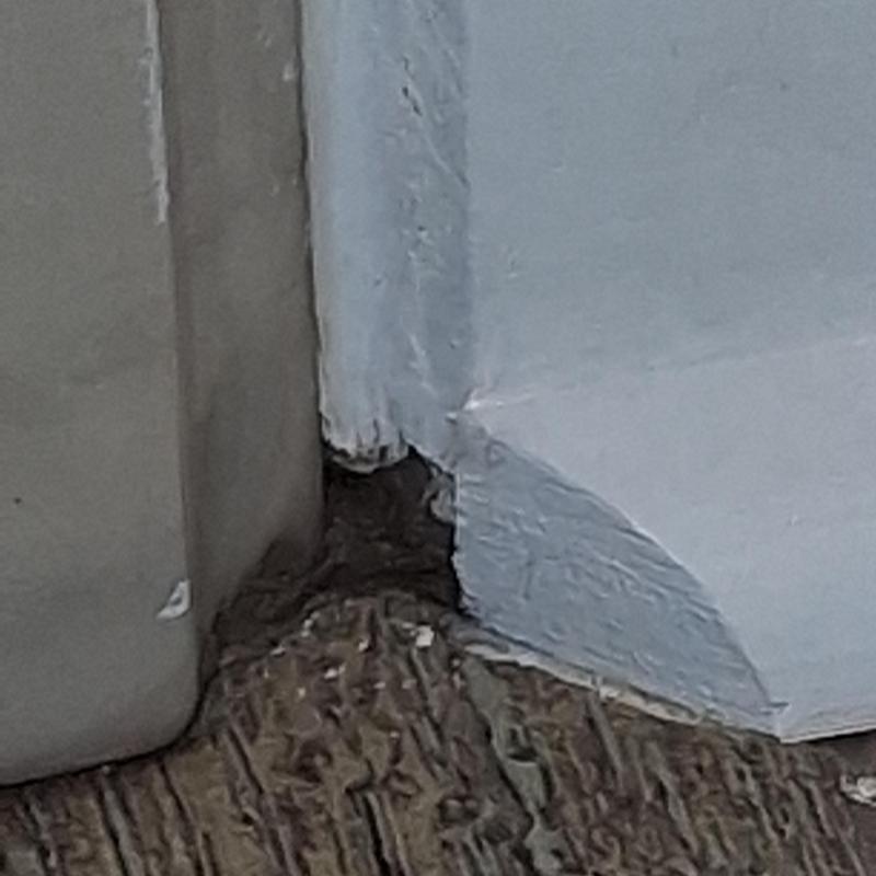 Bathtub base corner with silicone seal and painted wall