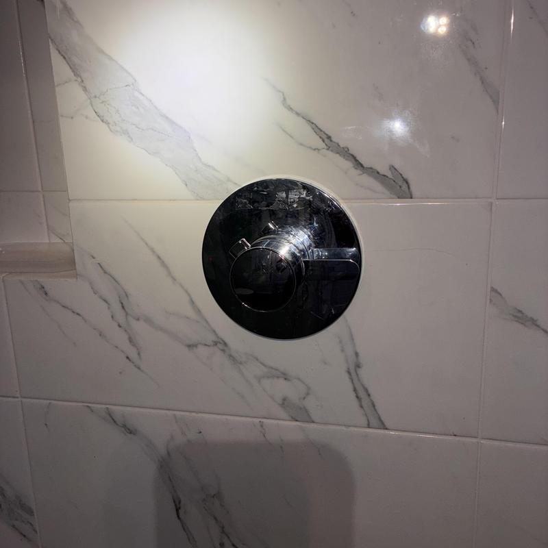 Grohe pressure balance shower valve on marble tile wall