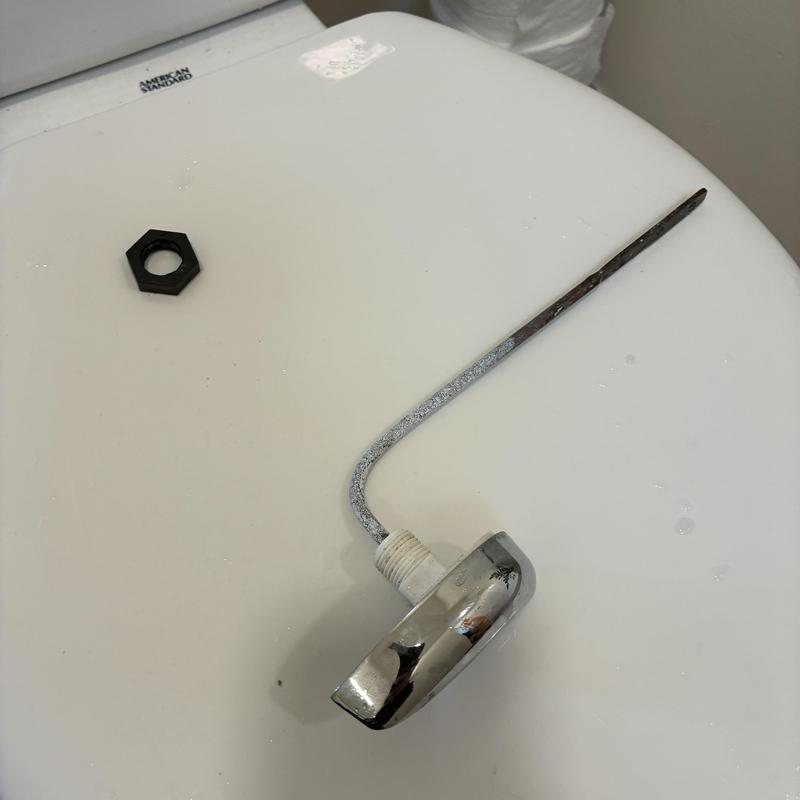 Toilet handle and lever removed on toilet tank lid
