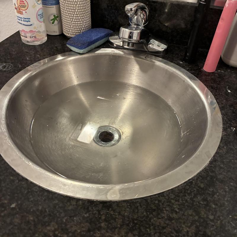 Basin drain and pop-up assembly in bathroom sink