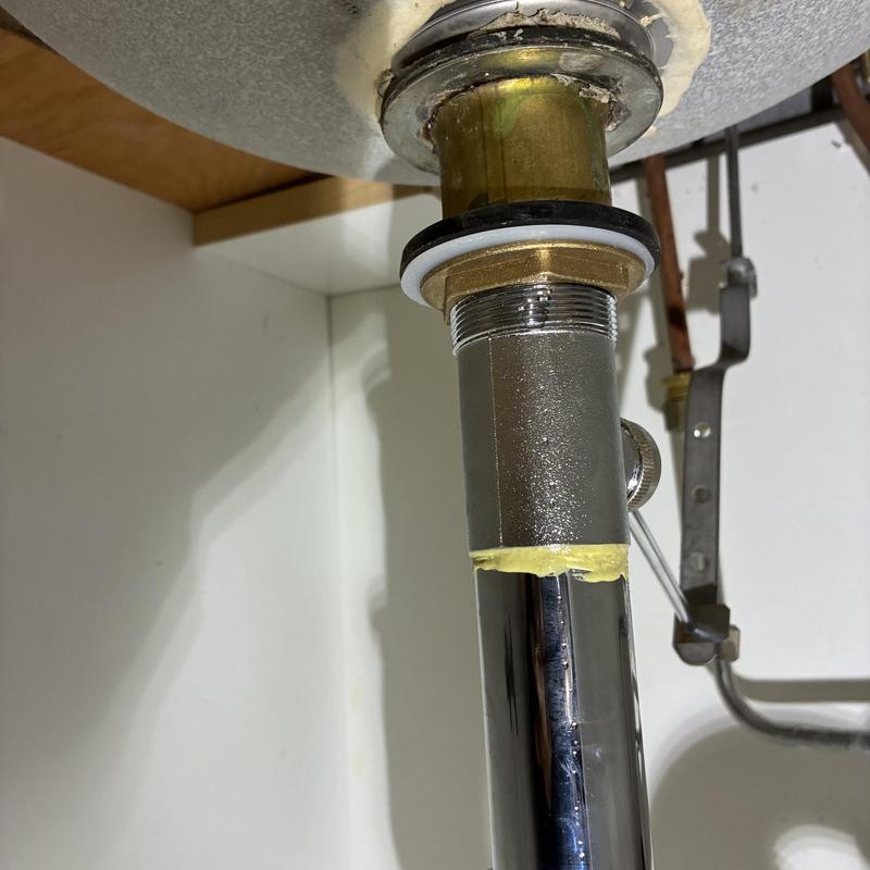 Pop-up drain assembly and basin pipe under sink