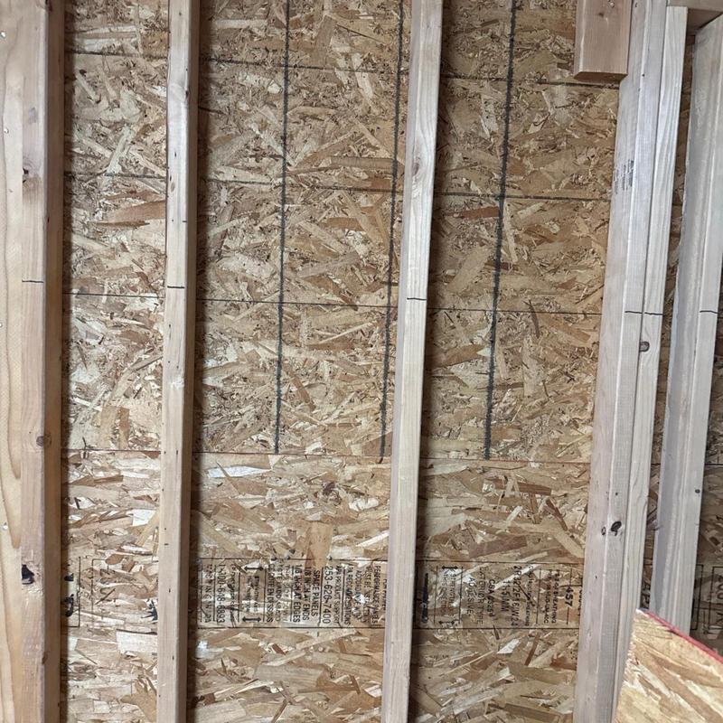Wall framing with plywood sheathing under construction