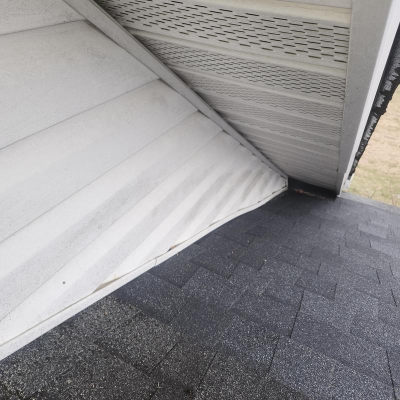 Garage wall flashing next to asphalt shingles roof