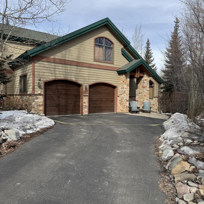 Asphalt shingle roof and gutter system at residential home Asphalt shingle roof and gutter system at residential home