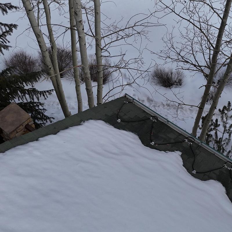 Heat tape on asphalt shingle roof with snow cover Heat tape on asphalt shingle roof with snow cover