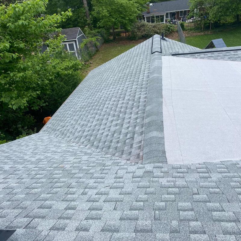 Asphalt shingle roof with flat membrane section