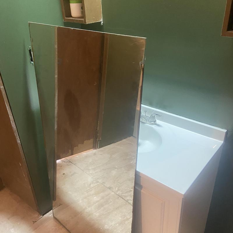 Bathroom vanity and sink with green painted walls