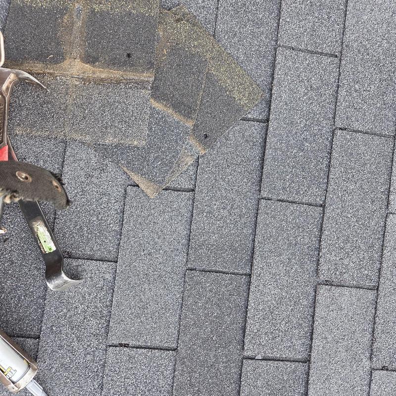 Asphalt shingles on roof with replacement tools