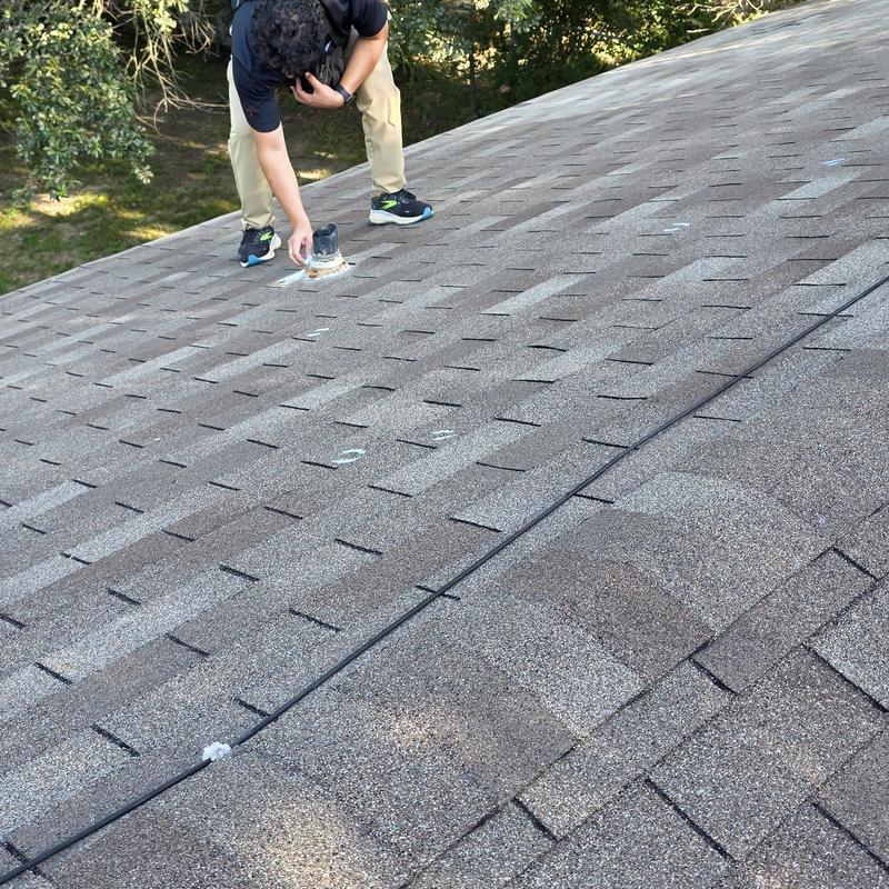Asphalt shingle roof with hail damage inspection