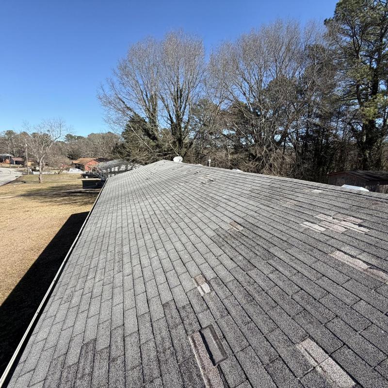 Roof decking with missing shingles on residential home