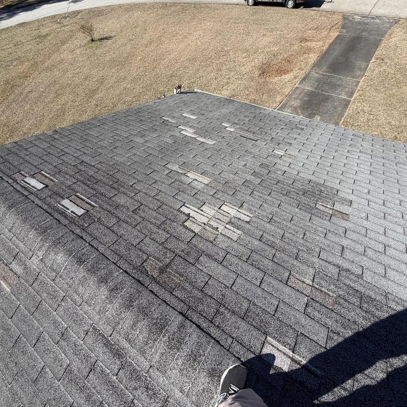 Roof shingles with multiple damaged and missing pieces