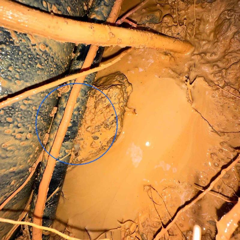 Underground plumbing pipes in muddy excavation site Underground plumbing pipes in muddy excavation site