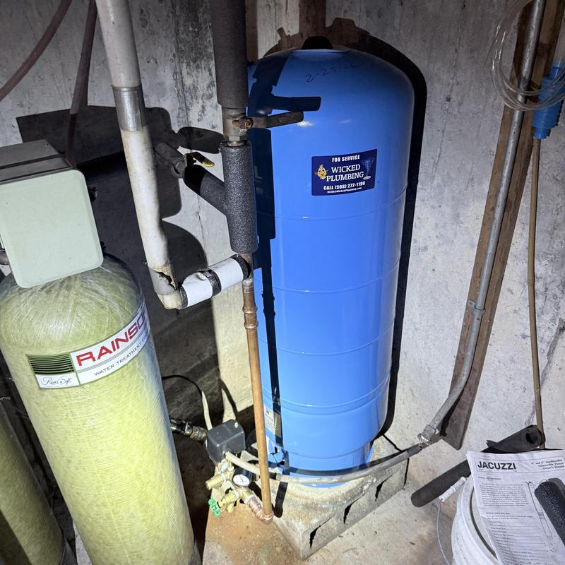 Well pressure tank installed in basement plumbing system
