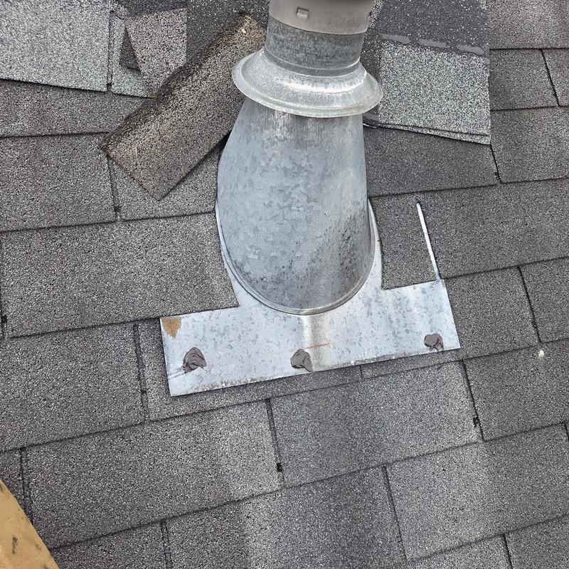 Roof vent flashing with replaced shingles and caulk