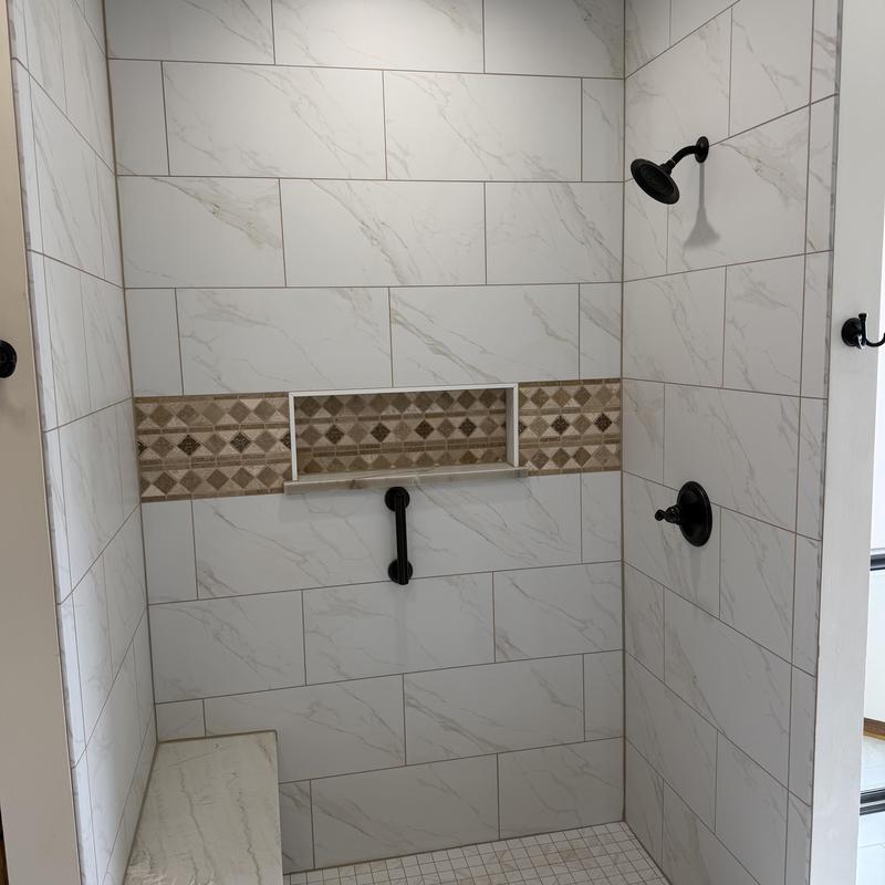 Walk-in shower with tile and matte black fixtures