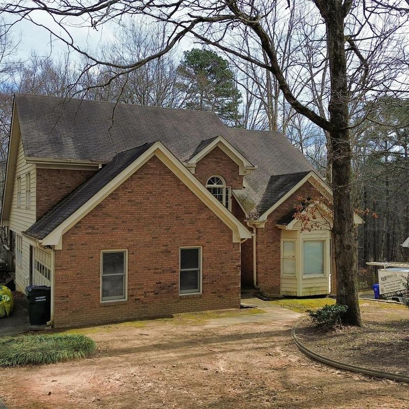 Asphalt shingle roof inspection on brick house