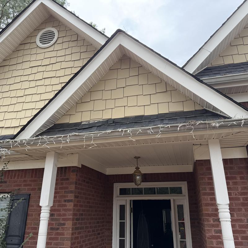 Roof shingles damaged above front porch entrance