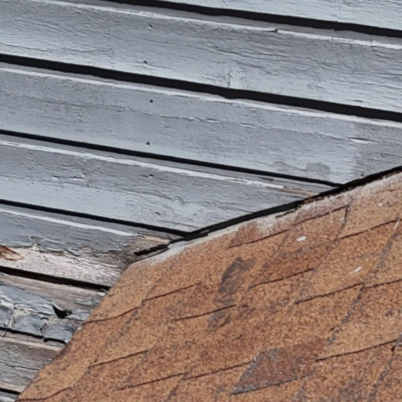 Asphalt shingle roof with wood siding damage Asphalt shingle roof with wood siding damage