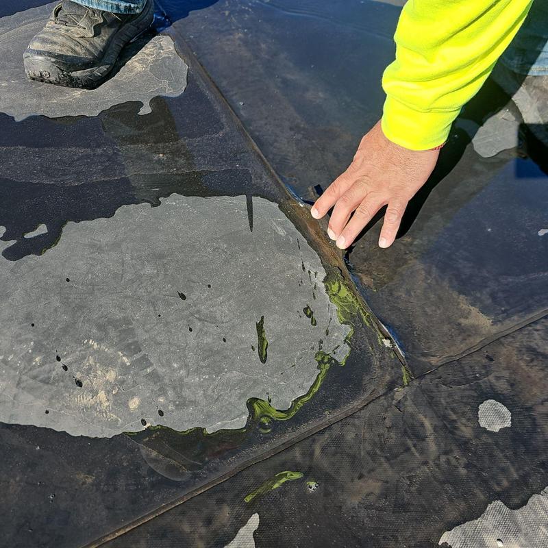 Flat roof membrane seam inspection with water pooling Flat roof membrane seam inspection with water pooling