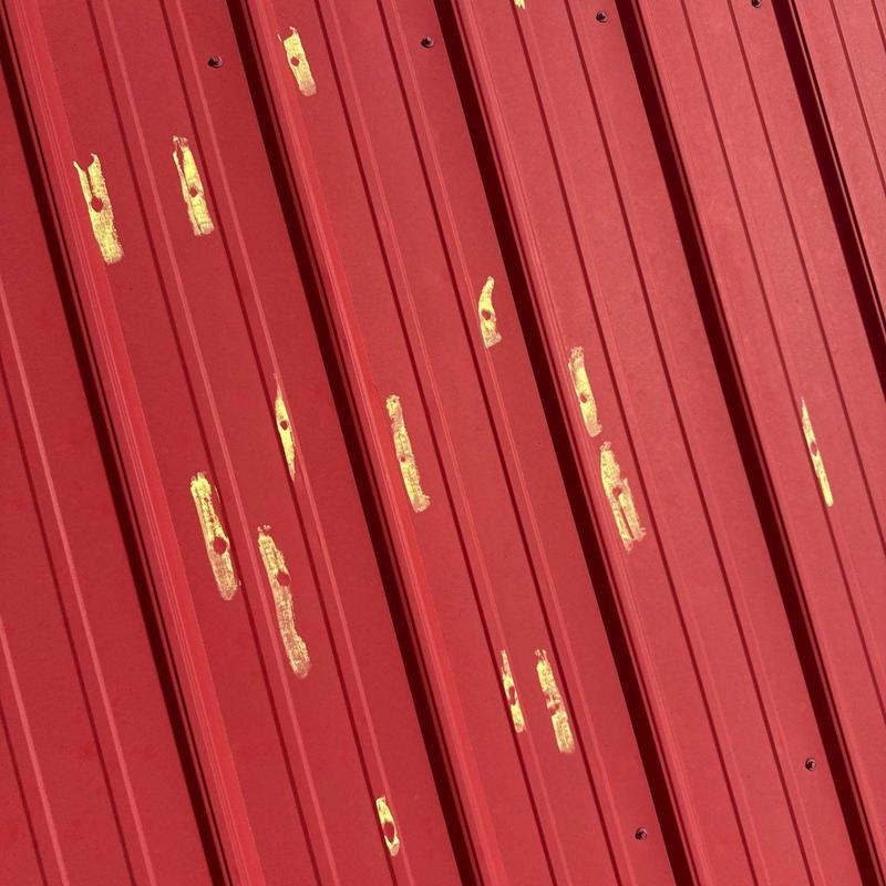 Metal roof panels with hail damage marks