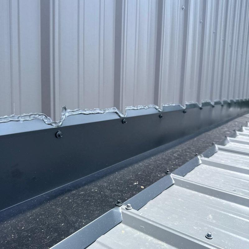 Metal roof flashing installation on corrugated panels