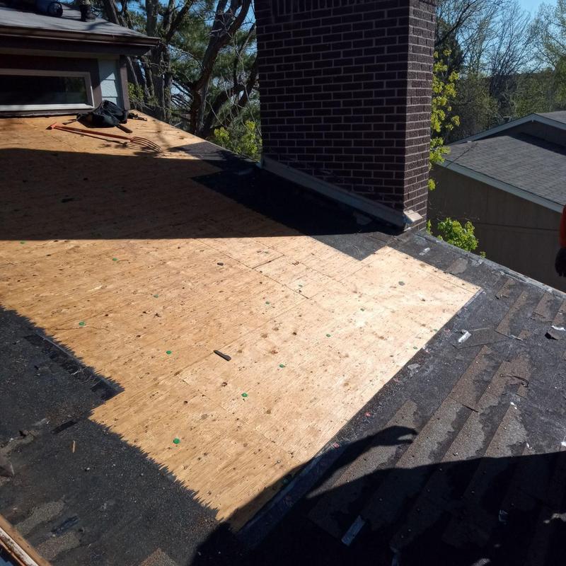 Roof decking replacement near brick chimney on residential roof Roof decking replacement near brick chimney on residential roof
