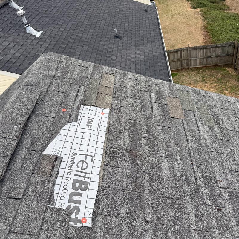 Roof shingles missing with exposed synthetic underlayment