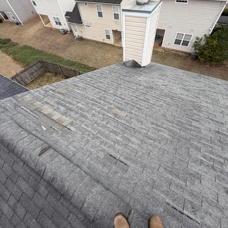 3-tab shingles with missing and damaged areas on roof