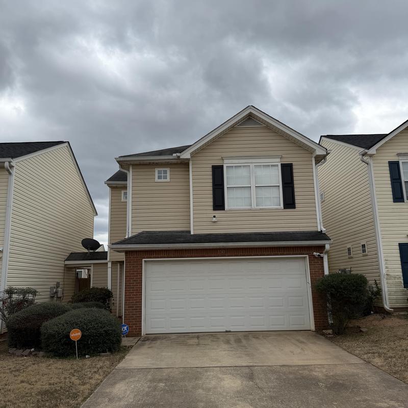 3-tab asphalt shingle roof with tarp cover on leak area