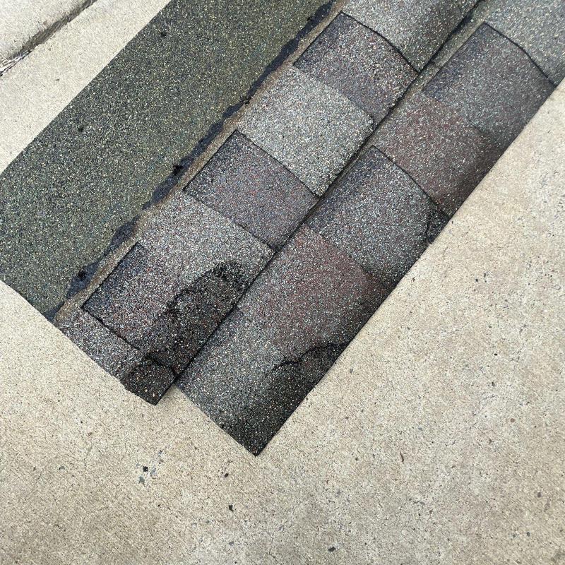 Asphalt roof shingles with hail damage areas