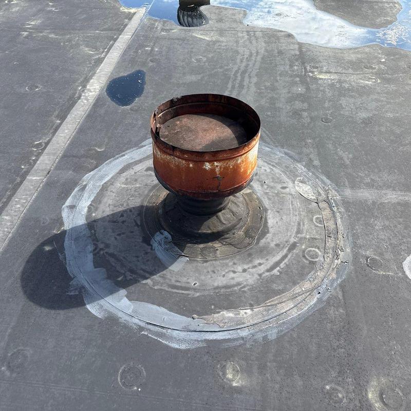 Roof vent pipe flashing with rust and sealant repairs