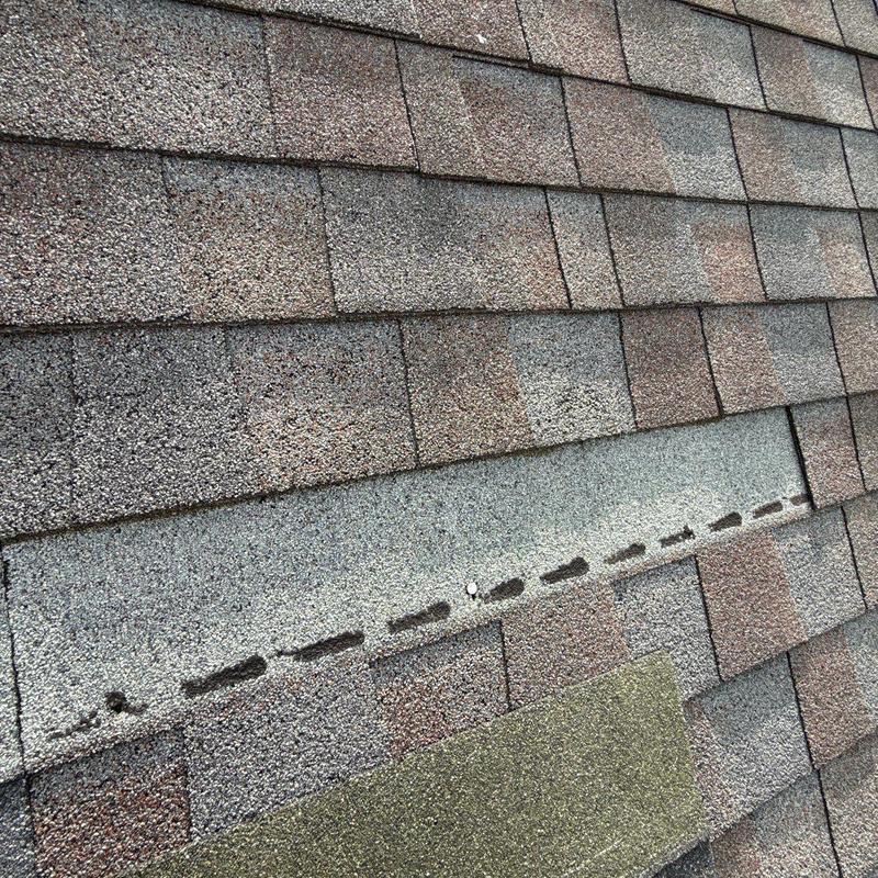 Asphalt shingles with hail damage and missing granules