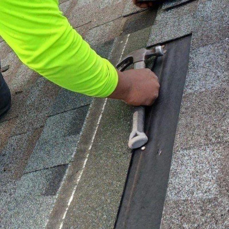 Roof flashing installation on shingled roof with hammer