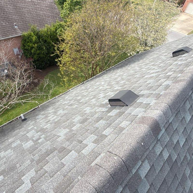 Asphalt shingle roof with vent and ridge shingles