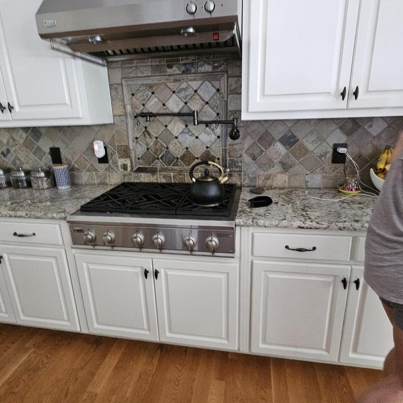 Gas cooktop with granite countertop and tile backsplash Gas cooktop with granite countertop and tile backsplash