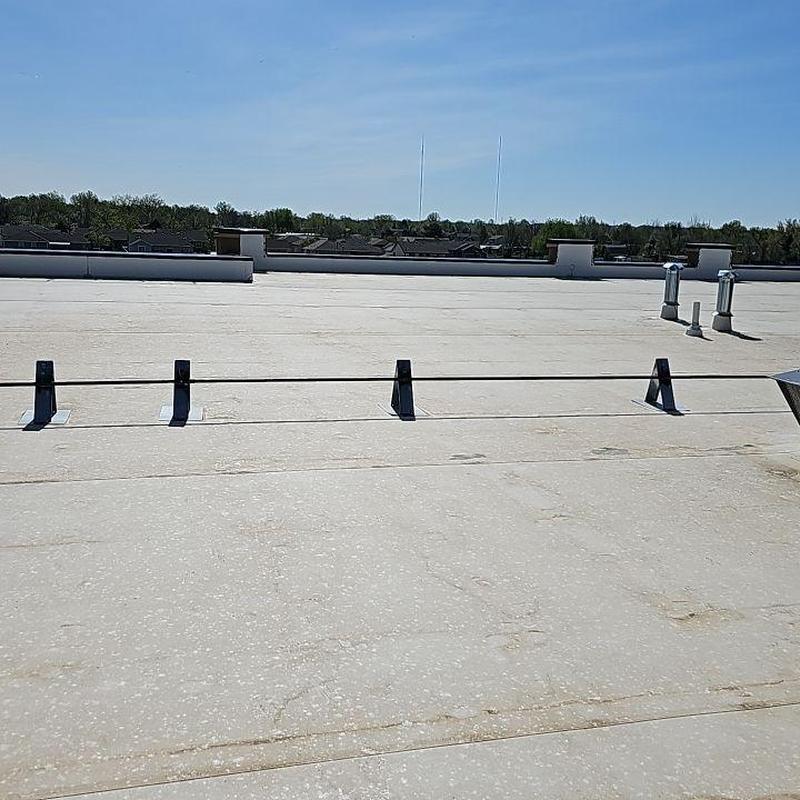 TPO roofing membrane with seam repair patches on flat roof TPO roofing membrane with seam repair patches on flat roof