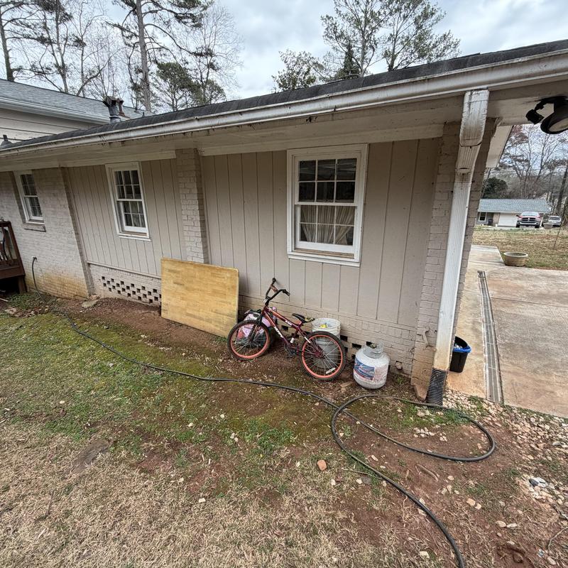 One-story downspout loose from brick wall