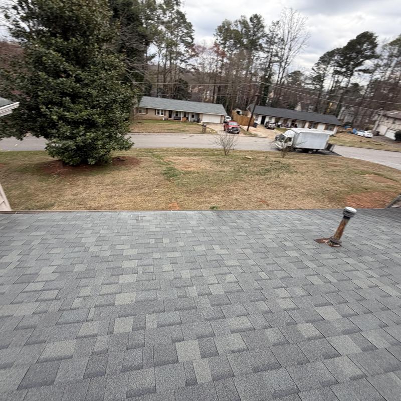 Shingle roof with vent pipe on two-story house