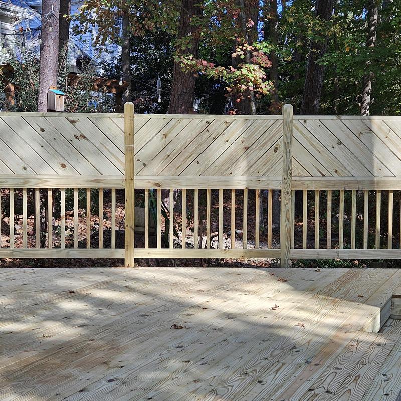 Wooden privacy fence and deck installation outdoors Wooden privacy fence and deck installation outdoors