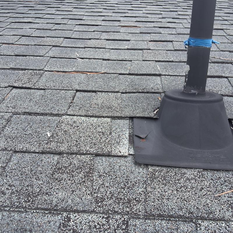 Asphalt shingles with wind damage and missing granules