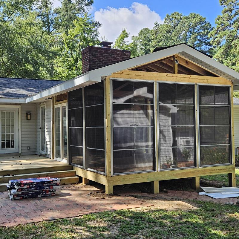 Four-season room with screened walls under construction Four-season room with screened walls under construction
