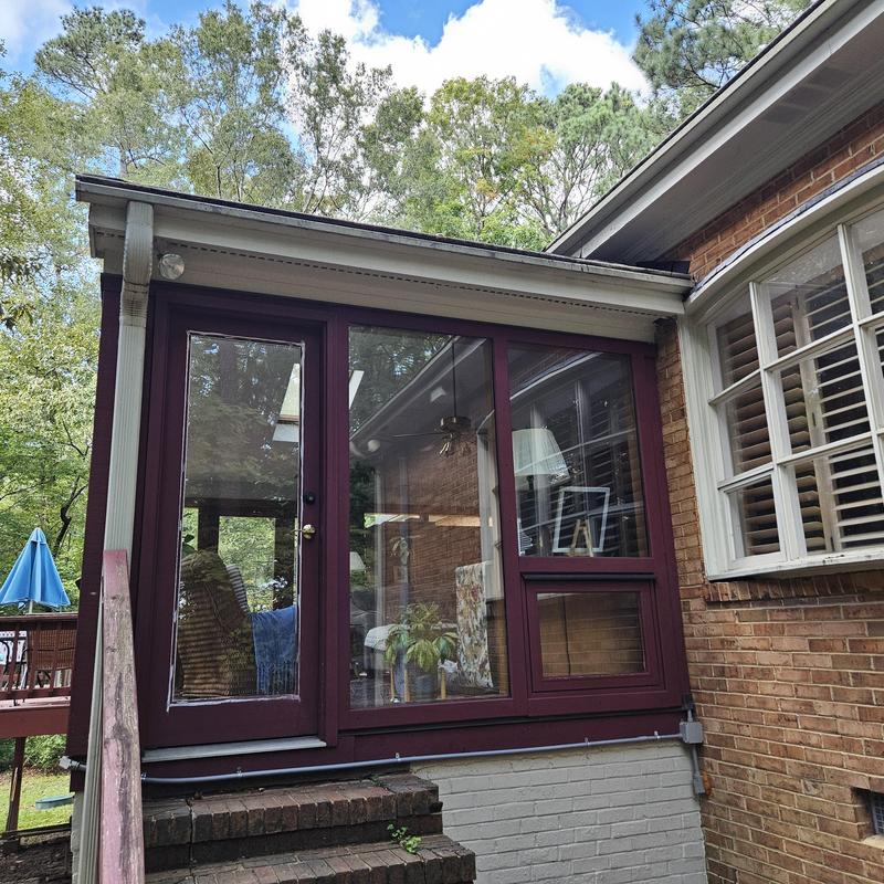 Sunroom window and door installation on brick home
