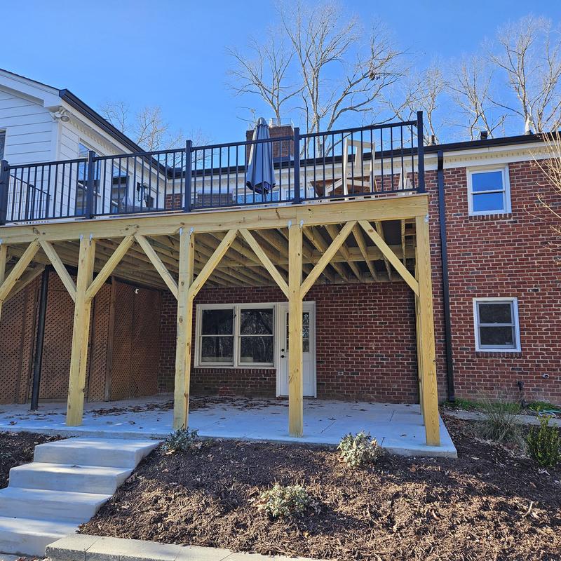 Wooden deck and patio with metal railing installation Wooden deck and patio with metal railing installation