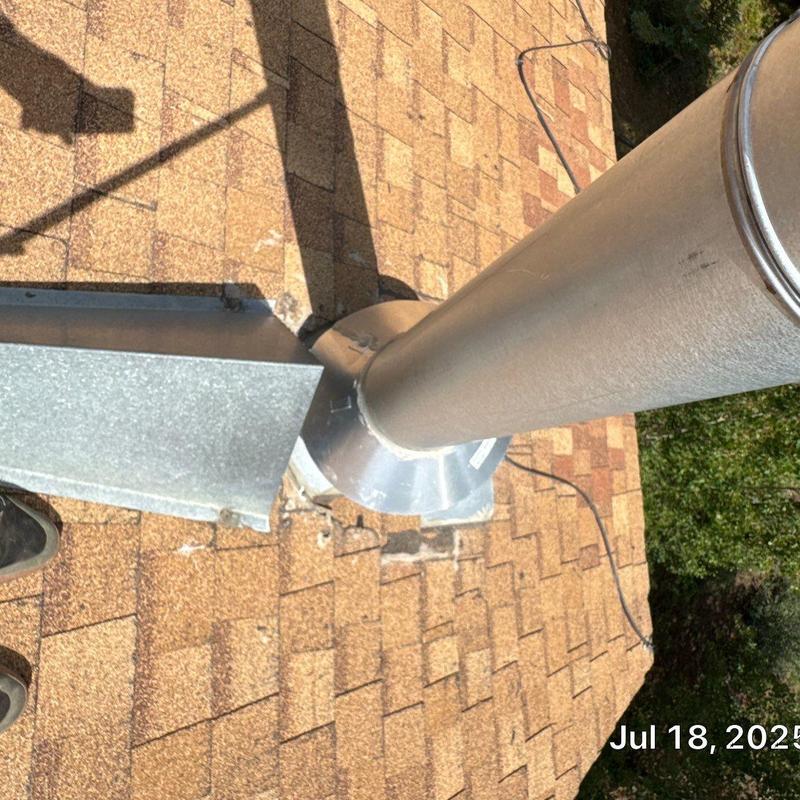 Metal chimney pipe flashing on asphalt shingle roof inspection Metal chimney pipe flashing on asphalt shingle roof inspection