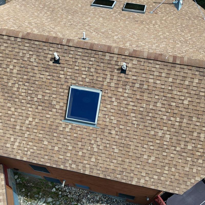 Asphalt shingle roof with skylight and vent pipes Asphalt shingle roof with skylight and vent pipes