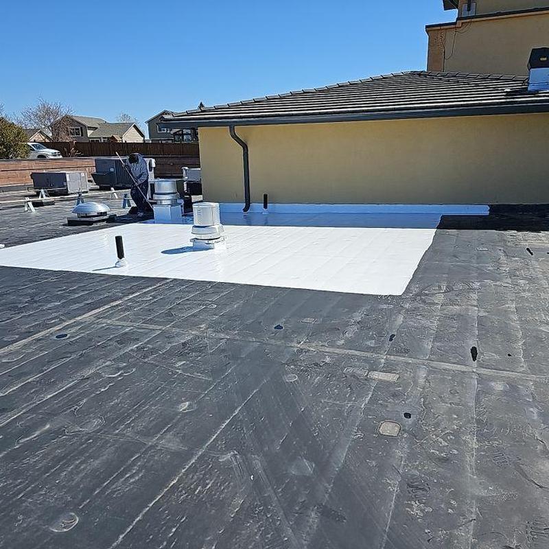 Flat roof EPDM section with new white coating applied Flat roof EPDM section with new white coating applied